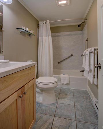 Private bathroom with shower and tub.