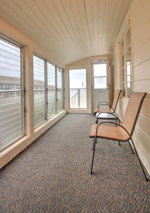 Designated seating in private enclosed porch.
