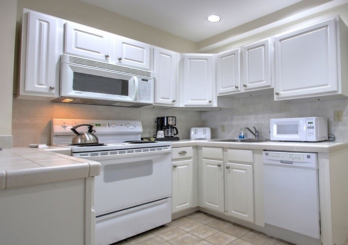 Standard kitchen appliances with recessed lighting.