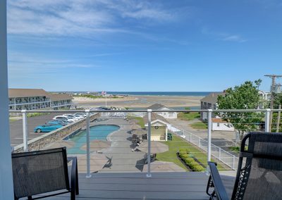 View from inside Room 70, looking through the sliding door toward the balcony and the ocean.