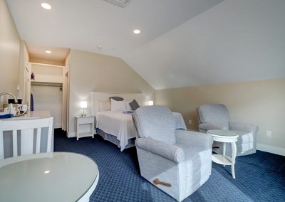 Photo taken from the balcony sliding door showing full layout of Room 71. Closet and door to bathroom in background.