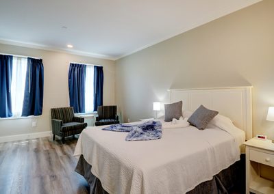 Room 72, view from the back of the room showing one of the two queen beds and the seating area.