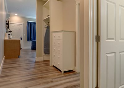 Room 74's hall area, showing bathroom door, second bedroom door and leading into main room.