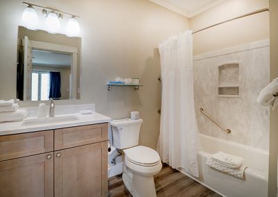 Full bathroom. Curtain rod has been replaced with sliding shower doors.