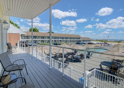 View from Room 75's designated outdoor seating, showing the view of the pool and beach.