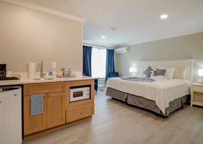 View of Room 77's wet bar and bed area.