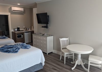 Two queen beds, wet bar, dining area.