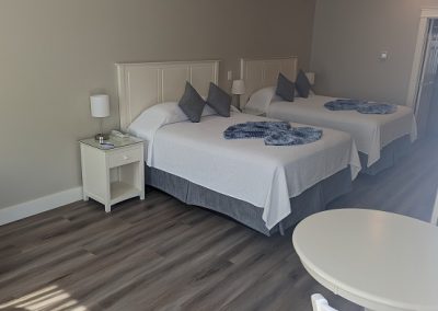 Family room with two queen beds and a dining table.