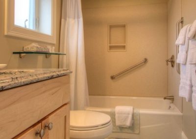 Private bathroom with tub with shower.