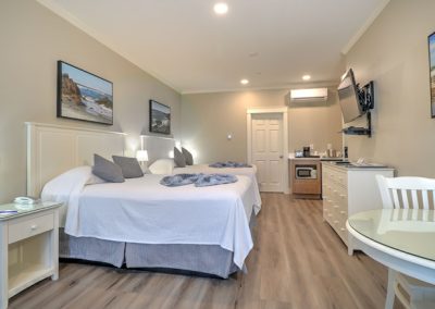 Two queen beds, wet bar, dining area.