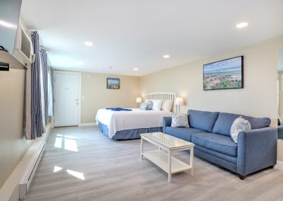 Looking back toward entrance, showing sofa and then king bed.
